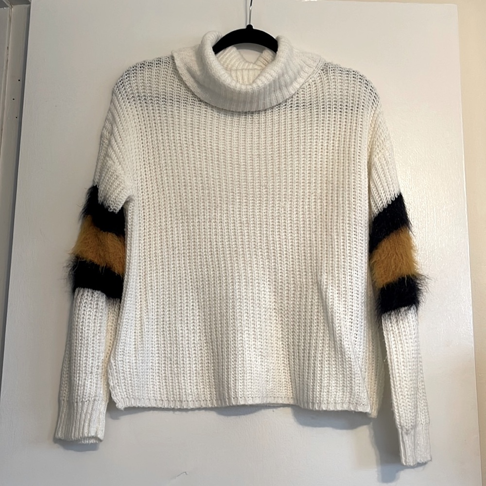 Knit turtle neck with arm fur detail.